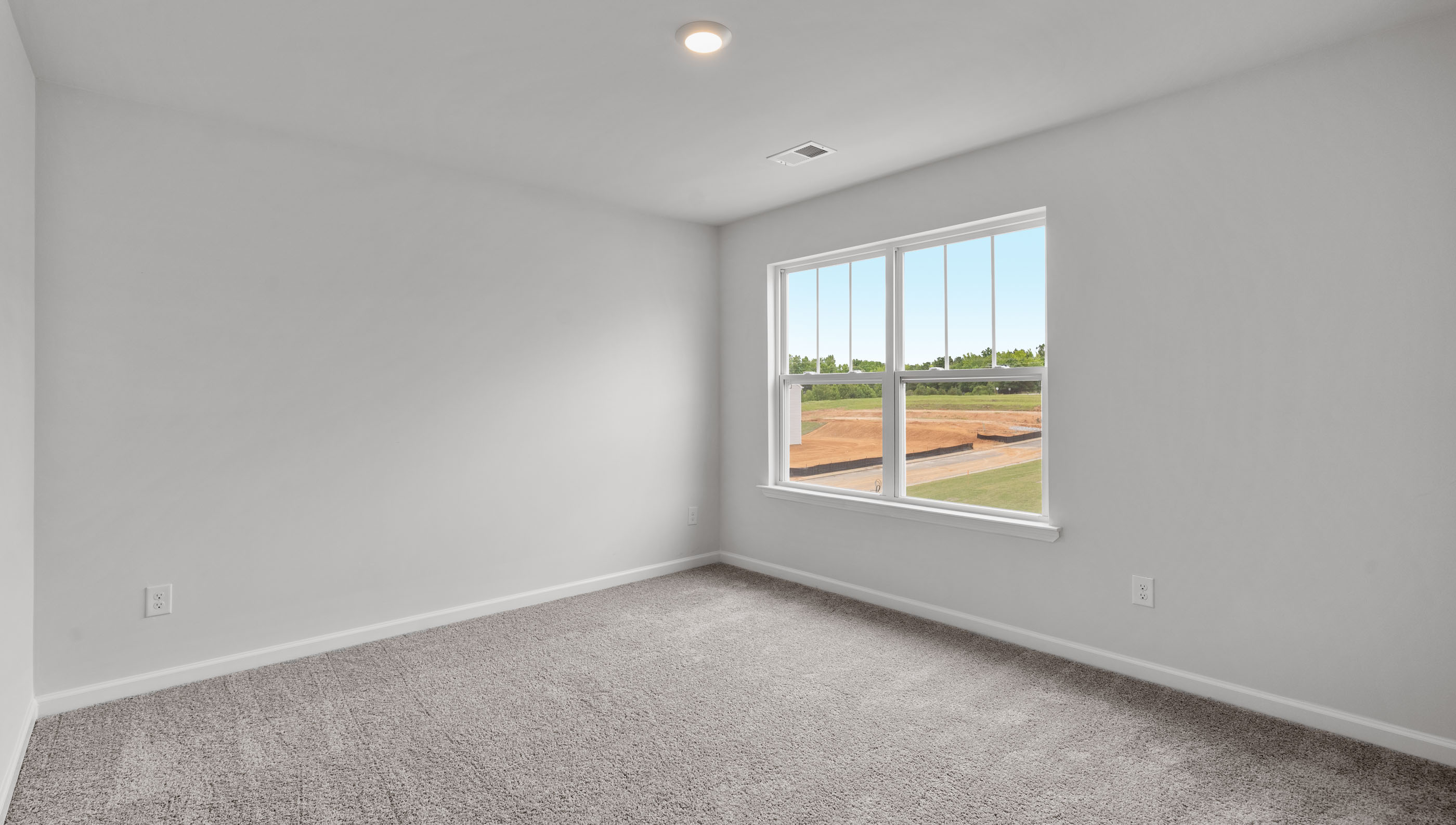Bedroom with carpet and window.