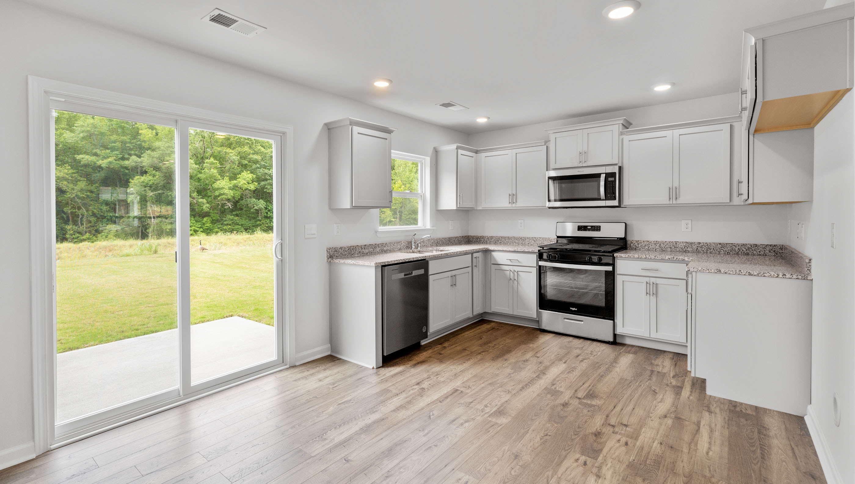 Kitchen with cabinets and windows.