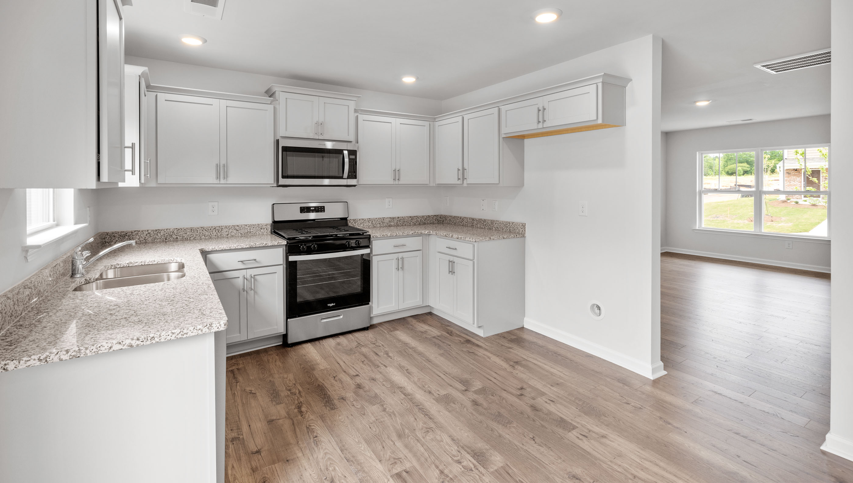 Kitchen with cabinets and windows.