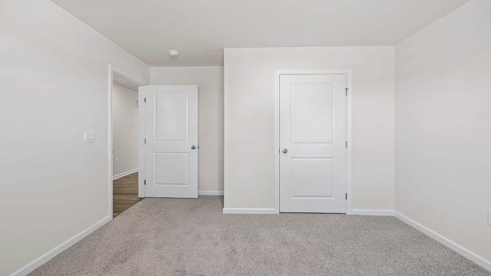 Bedroom with window and carpet.
