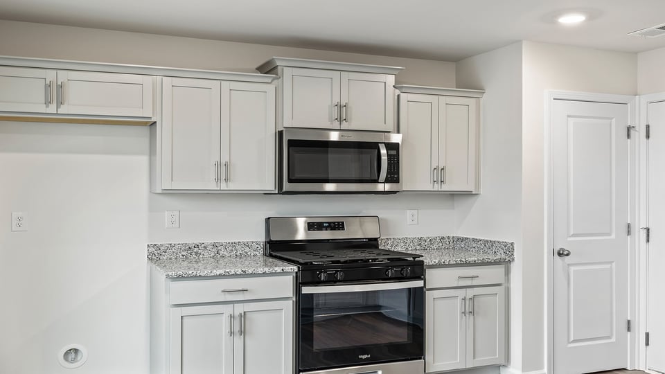 Kitchen features stainless steel appliances.