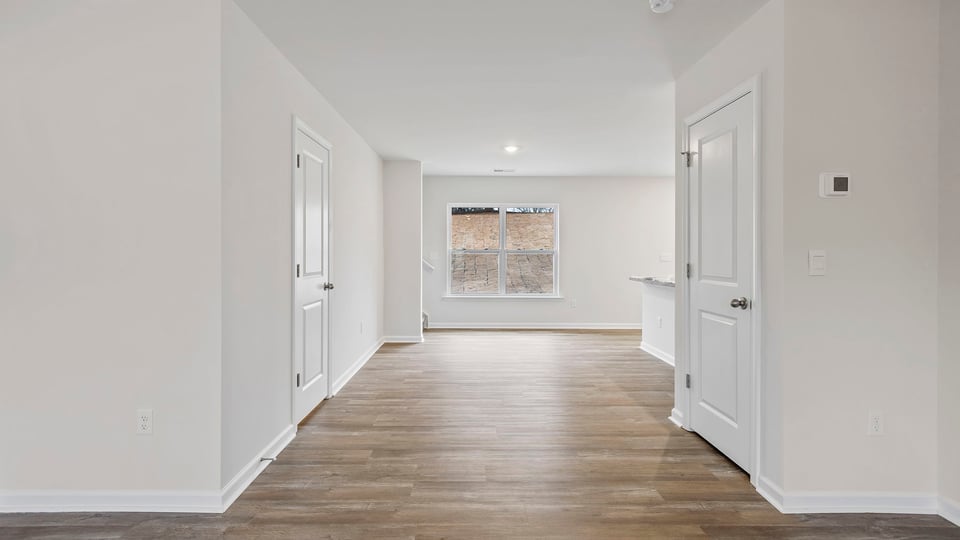 Closer view of the dining room with large window.