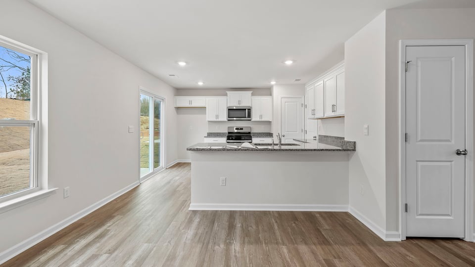 View of the open kitchen with lots of windows and recessed lighting.