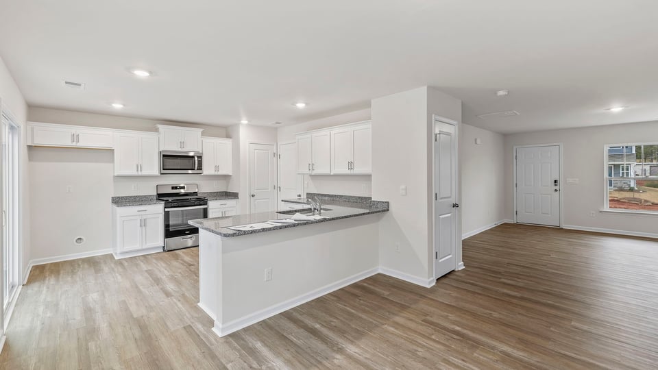 View of the kitchen and the entrance into the family room.