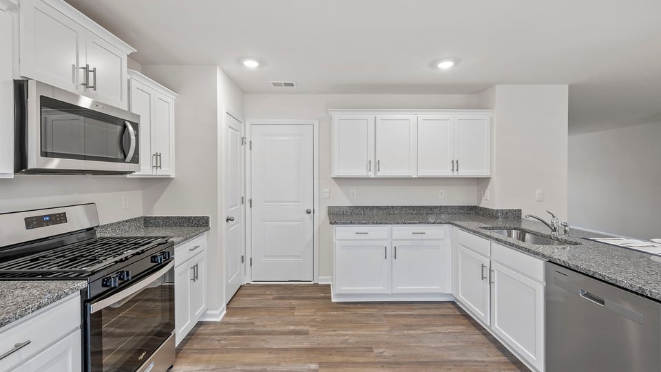 Kitchen and island with quartz countertops.
