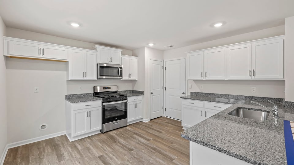 Kitchen features stainless steel appliances.