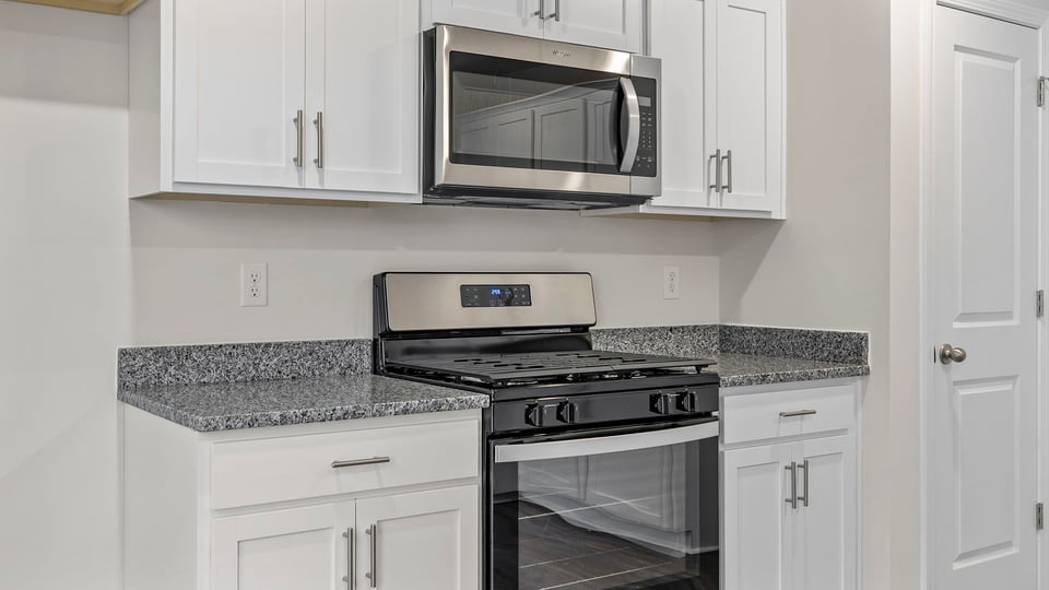 Kitchen features stainless steel appliances.