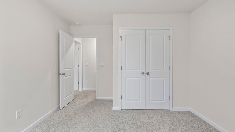 Bedroom with window and carpet.