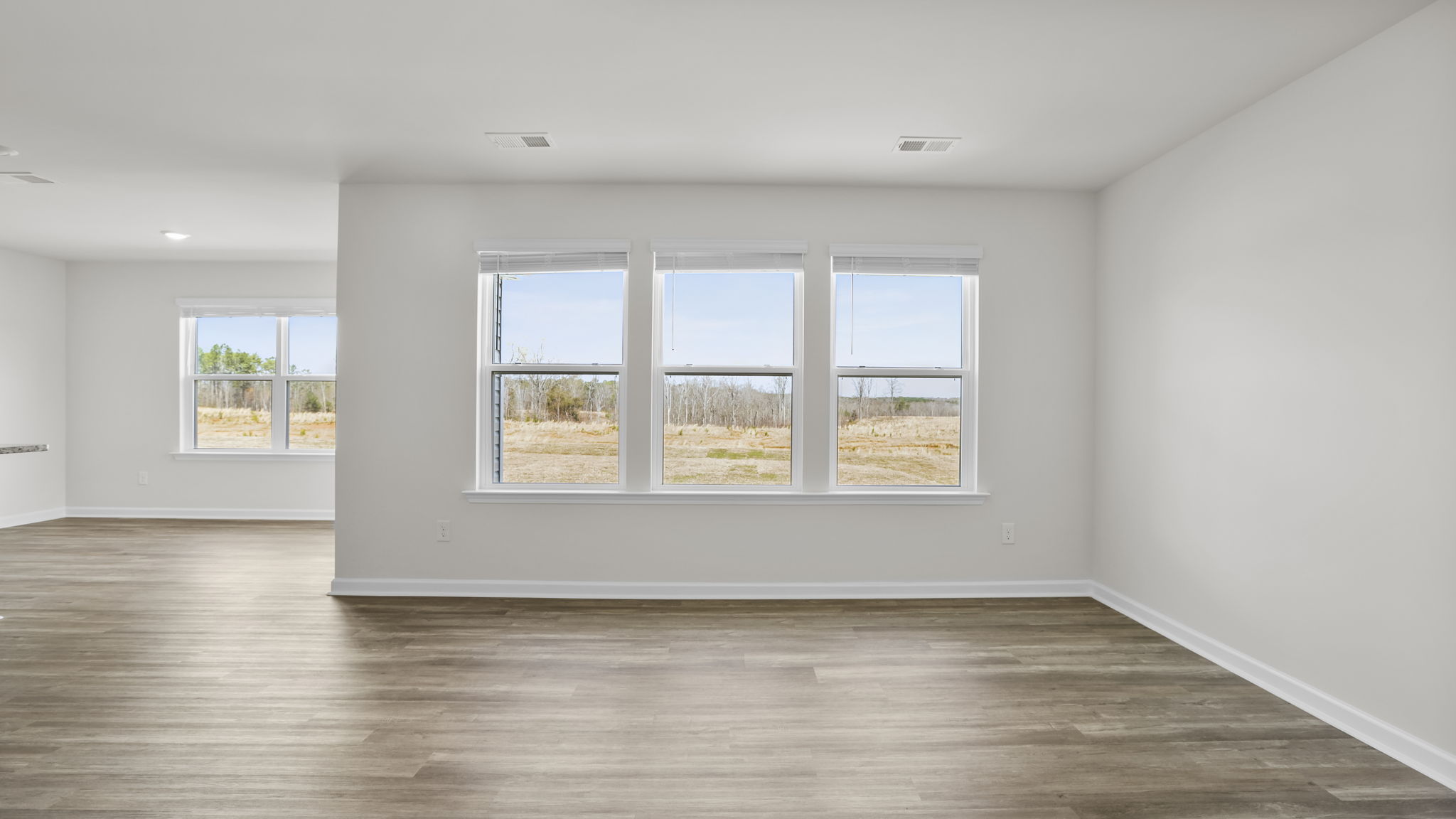 Living room with three large windows.
