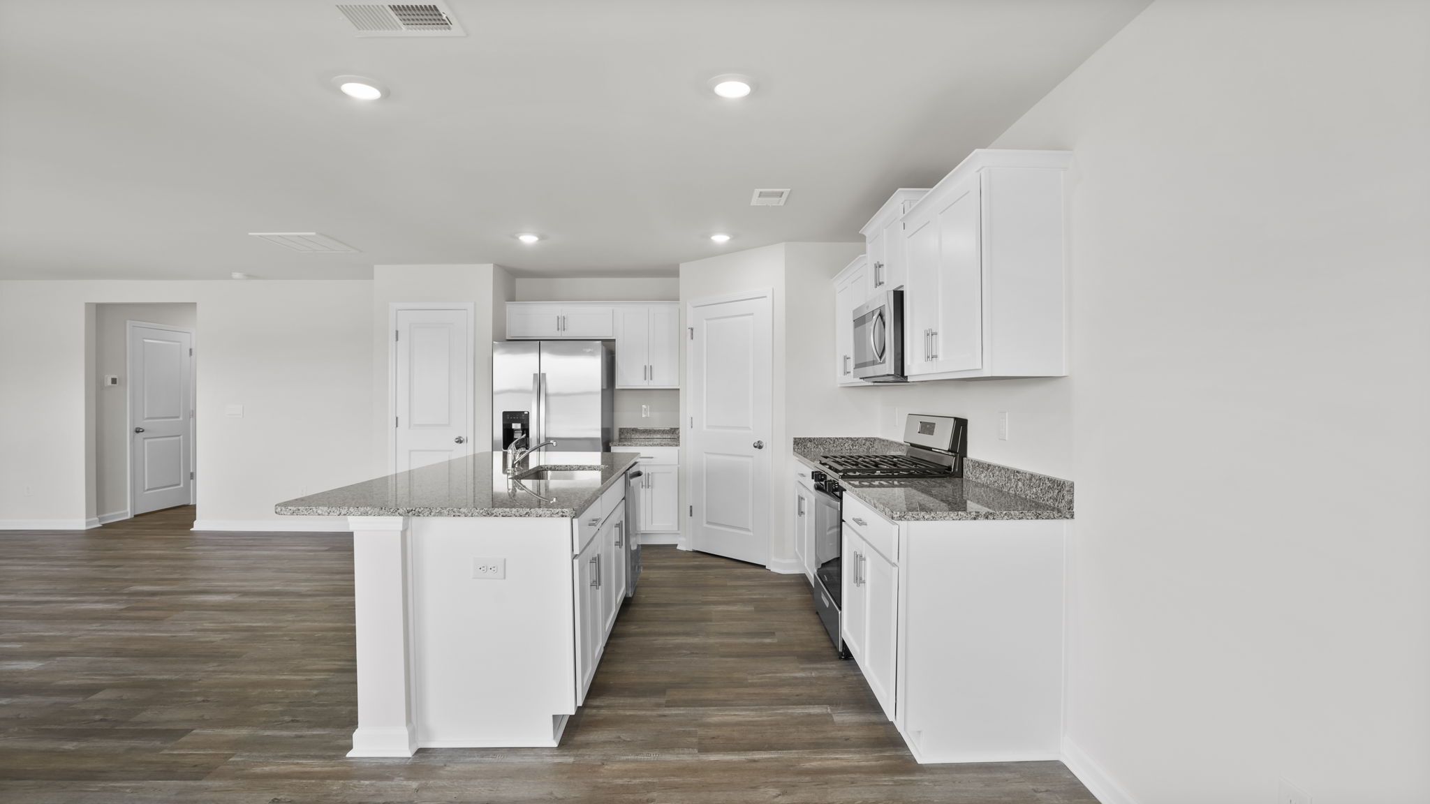 Kitchen and island have quartz countertops.