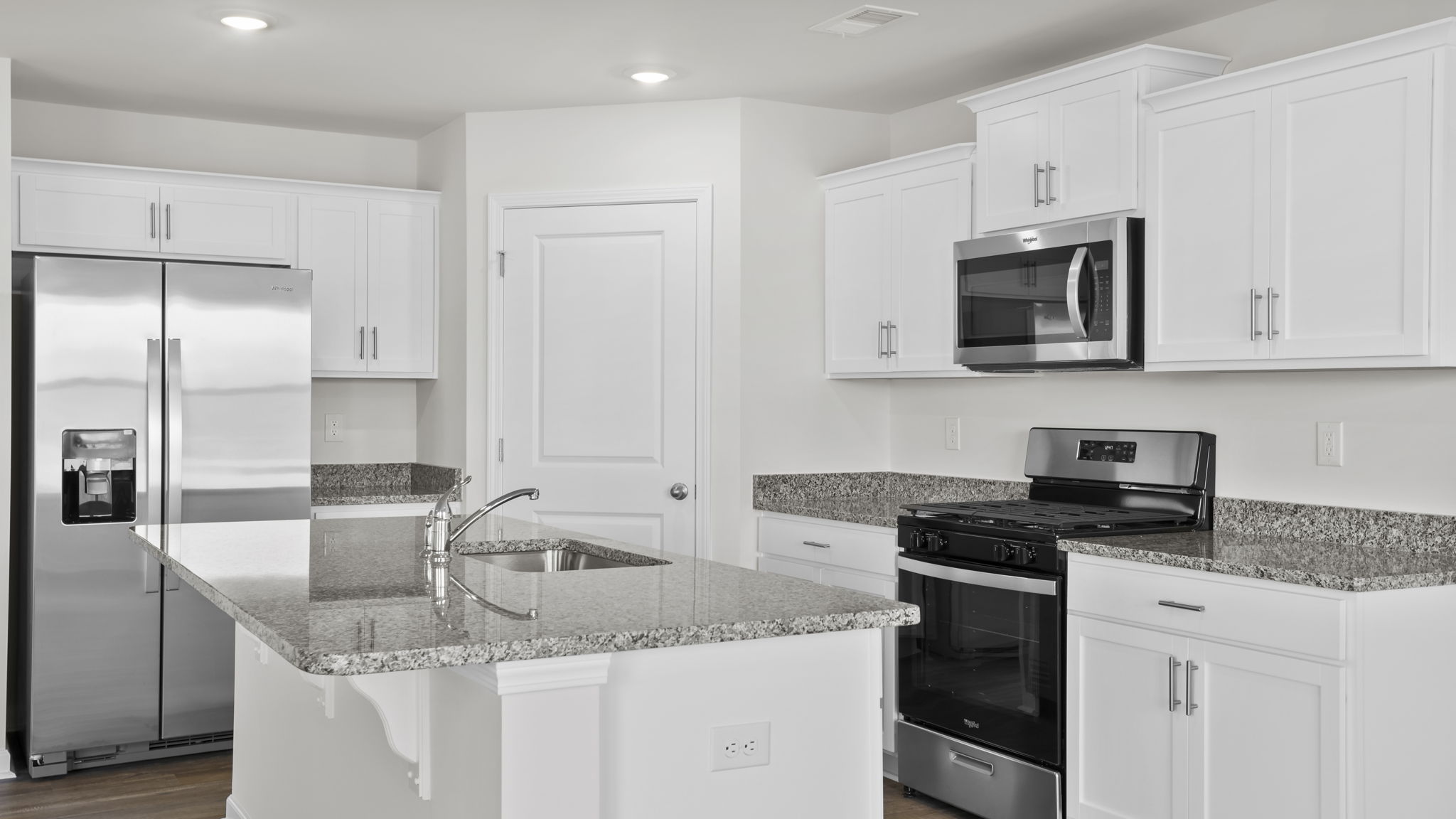 Kitchen features stainless steel appliances.