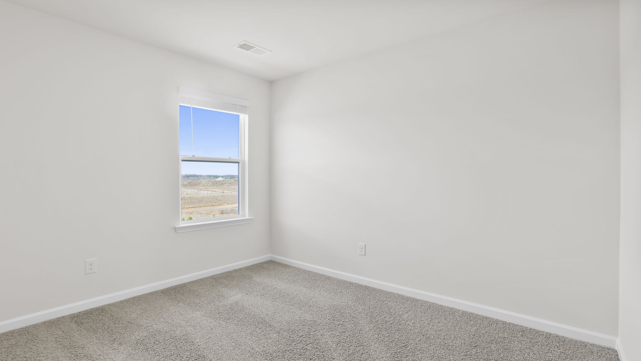 Bedroom with window and carpet.