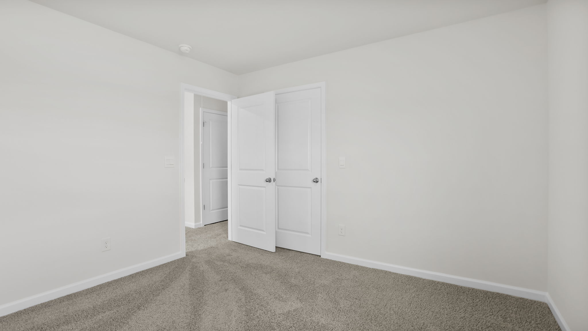 Bedroom with window and carpet.