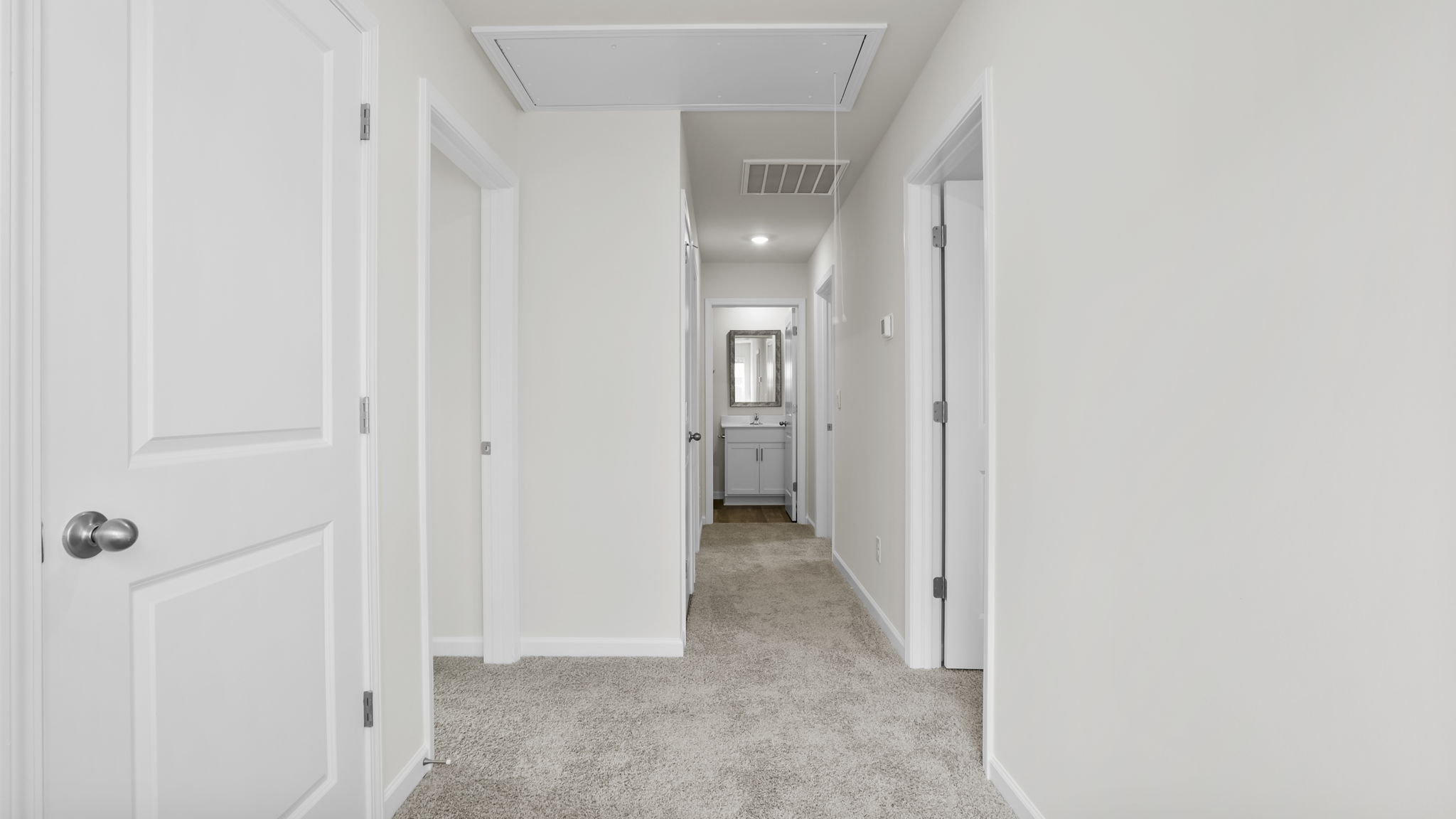 View of landing at top of the stairs and hallway to bedrooms.