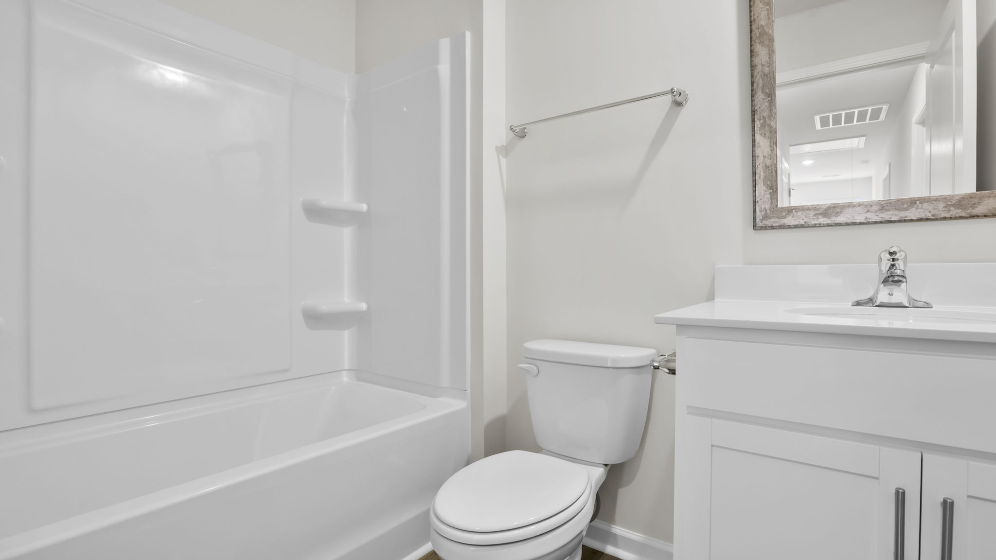 Hall bathroom with vanity and combination shower / tub.