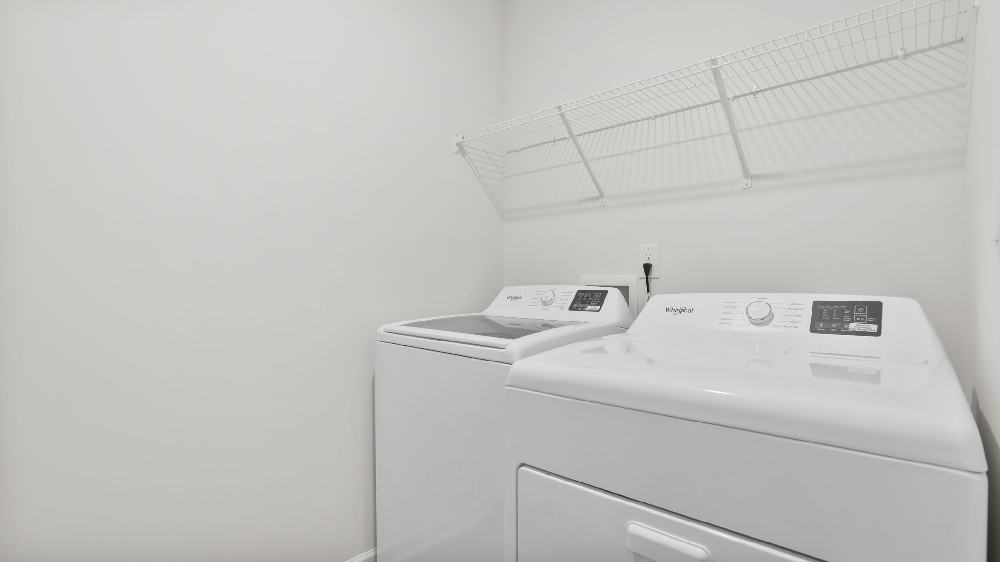 Walk-in laundry room with wire shelving.