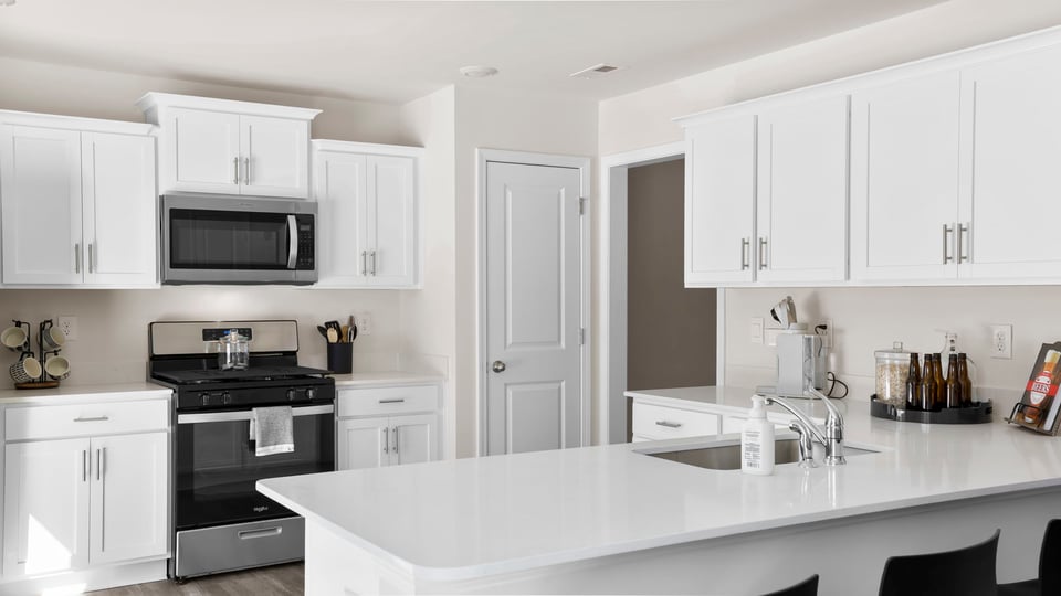 Kitchen with windows and cabinets.