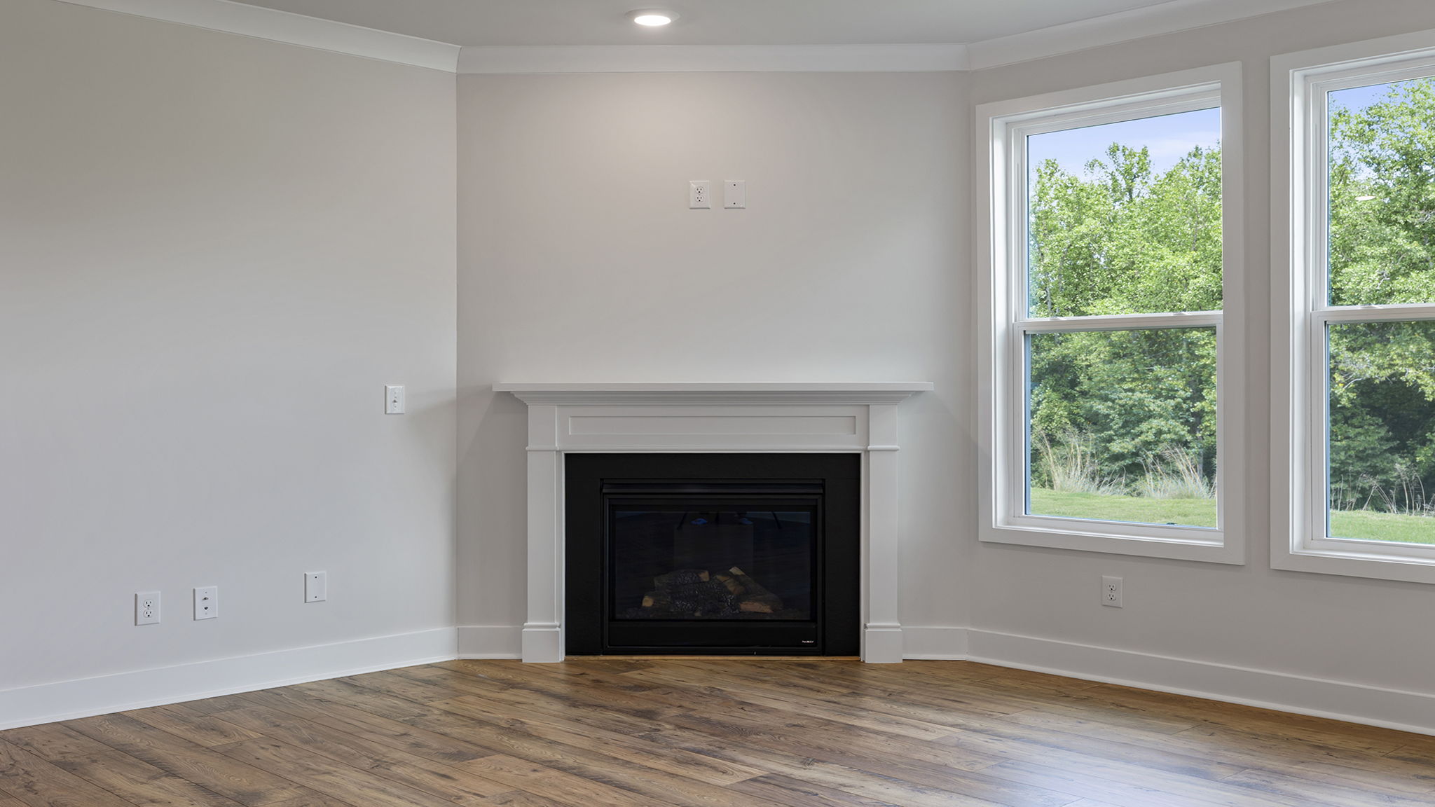 Living room with fireplace and window.