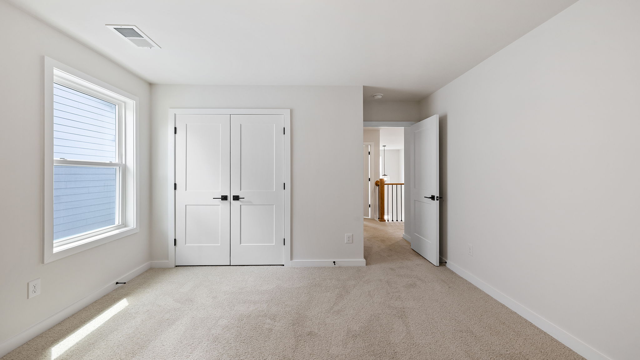 Bedroom with carpet and window.