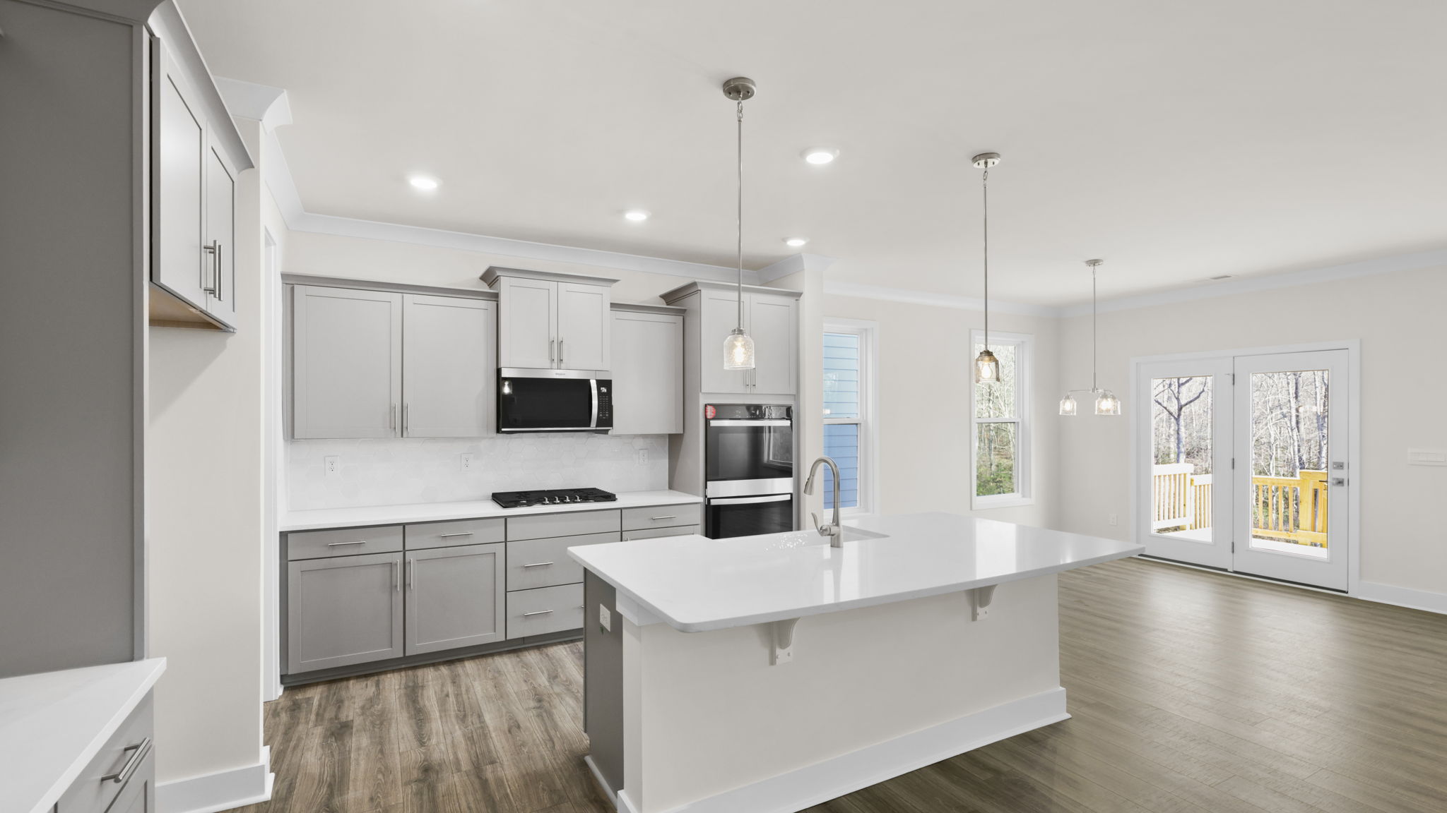 Open kitchen with pendulum lighting and island.