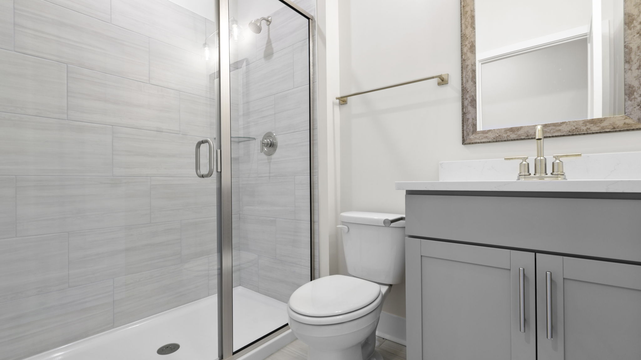 Main level full bathroom with vanity and walk-in shower.