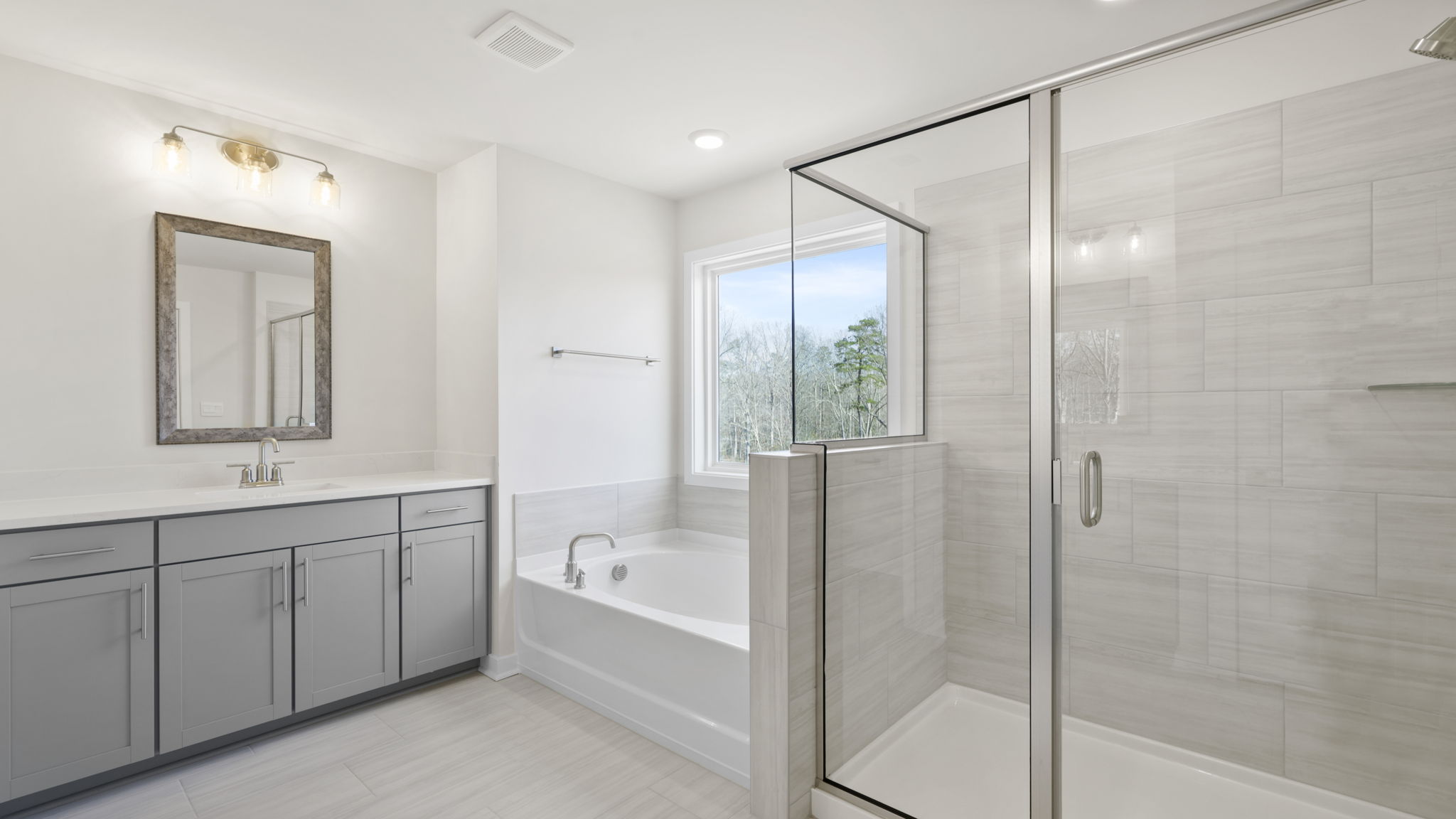 Primary bathroom with vanity, walk-in shower and garden tub.