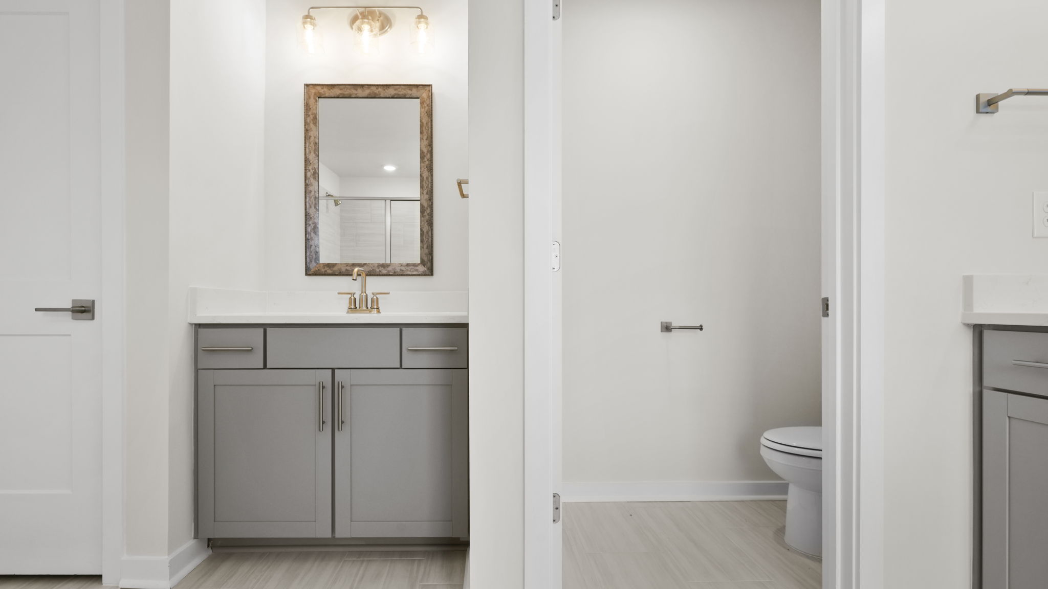 Primary bathroom second vanity and water closet.