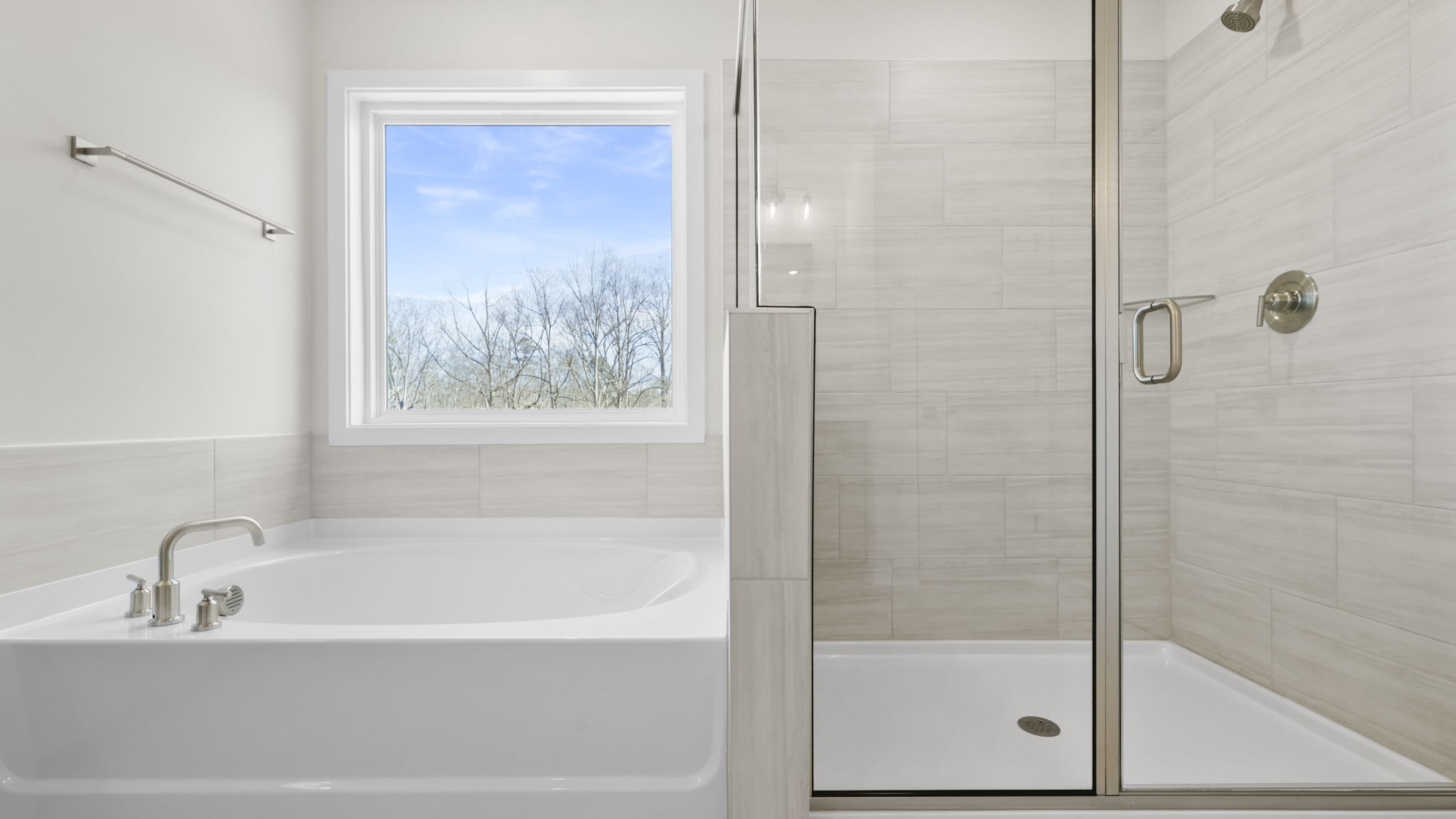 Primary bathroom walk-in shower and garden tub.
