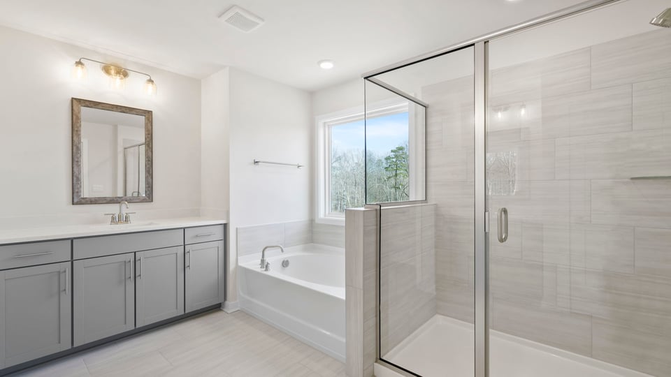 View of primary bathroom with gorgeous walk-in tiled shower, soaking tub and dual vanity areas.