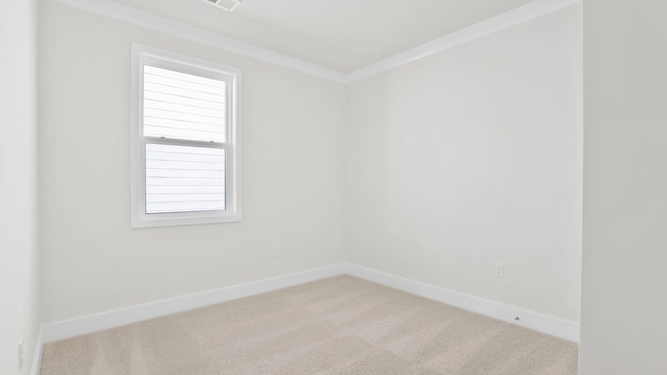Bedroom with carpet and window.