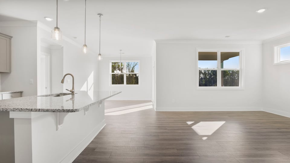 Living room with fireplace and windows.