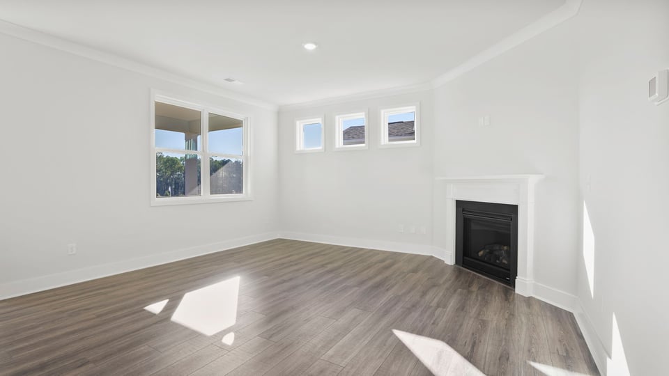 Living room with fireplace and windows.