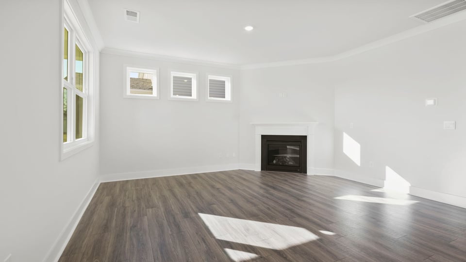 Living room with fireplace and windows.