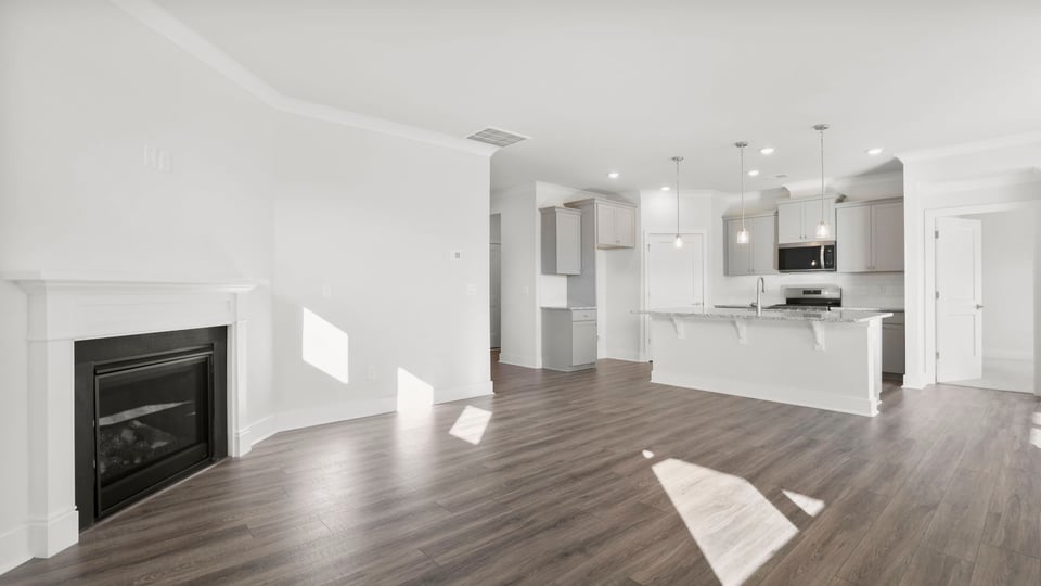 Living room with fireplace and windows.