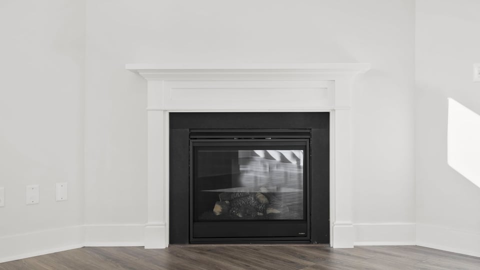 Living room with fireplace and windows.