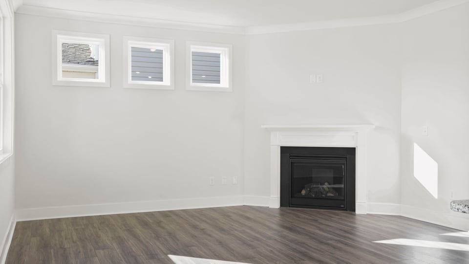 Living room with fireplace and windows.