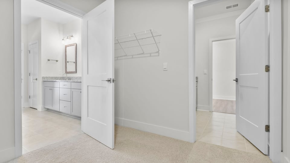 Primary closet with shelf.