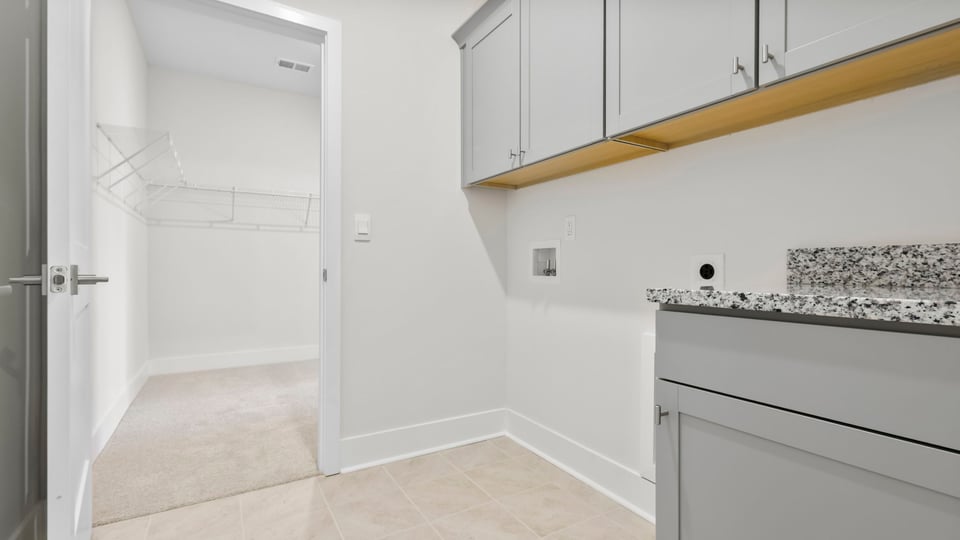 Laundry room with cabinets.