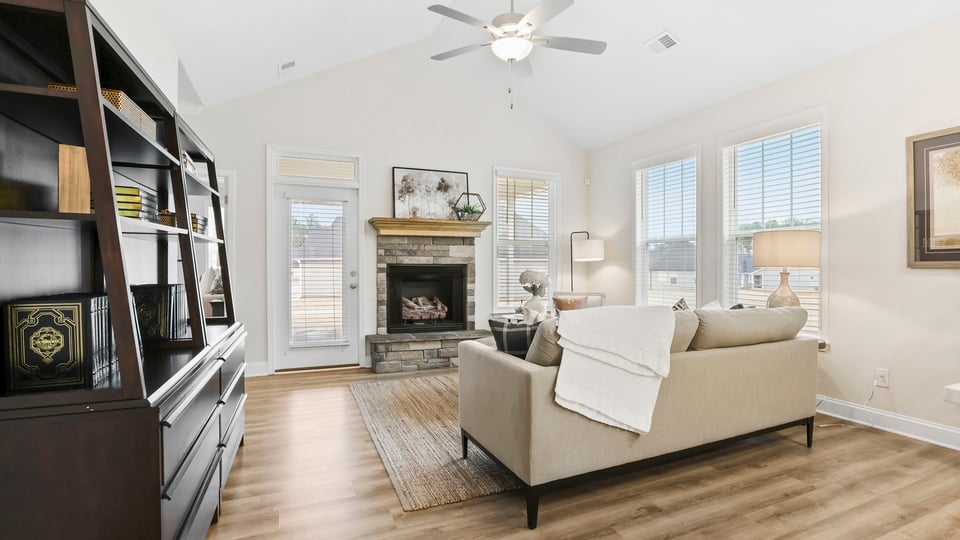 Living room with fireplace and windows.