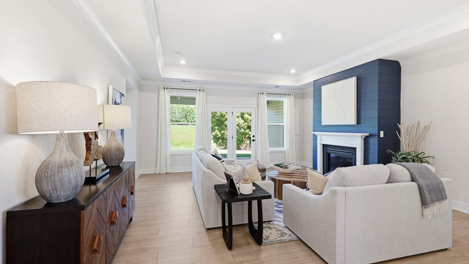Living area with fireplace and windows.