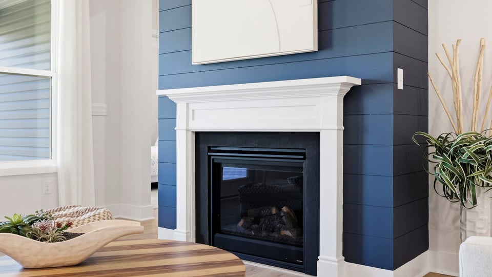 Living area with fireplace and windows.