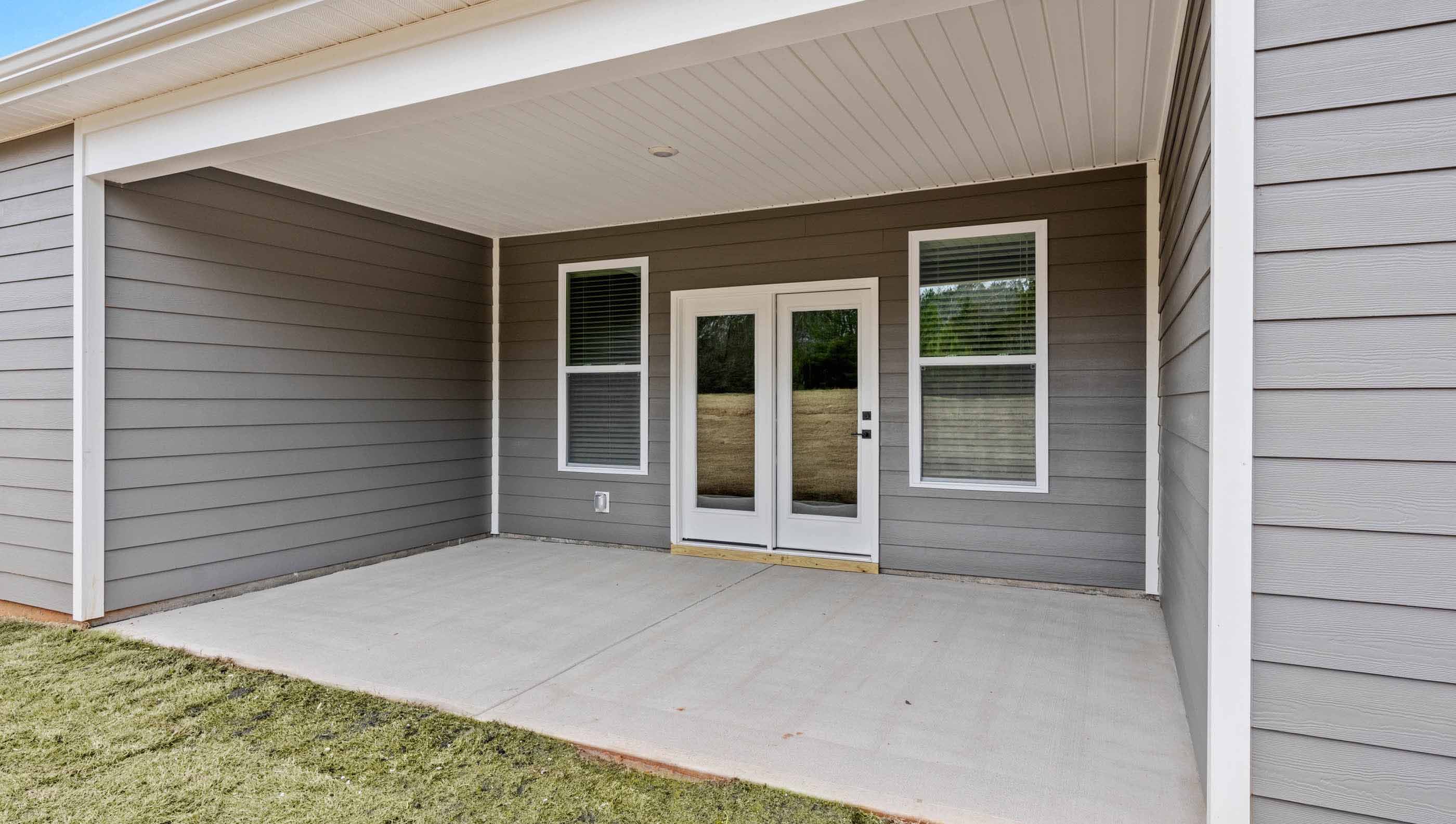 Back exterior with covered patio.