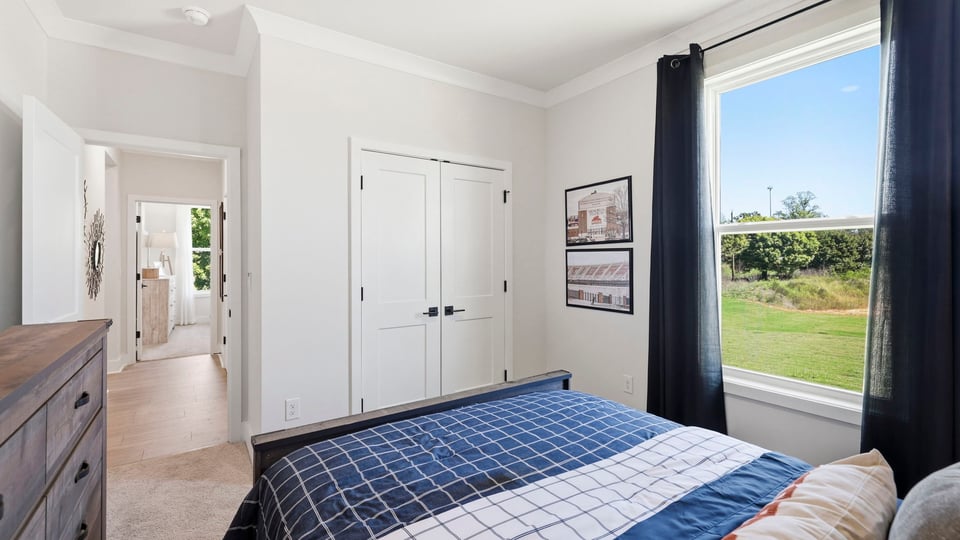 Bedroom with carpet and windows.