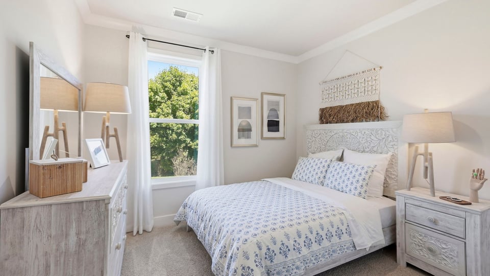 Bedroom with carpet and windows.