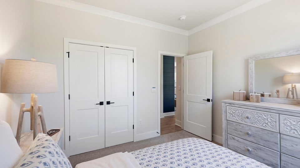 Bedroom with carpet and windows.