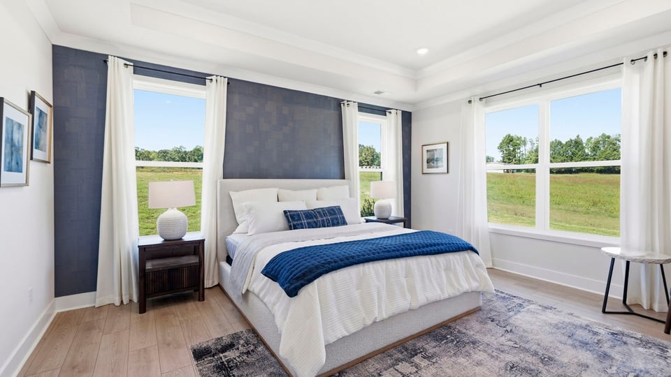 Bedroom with carpet and windows.