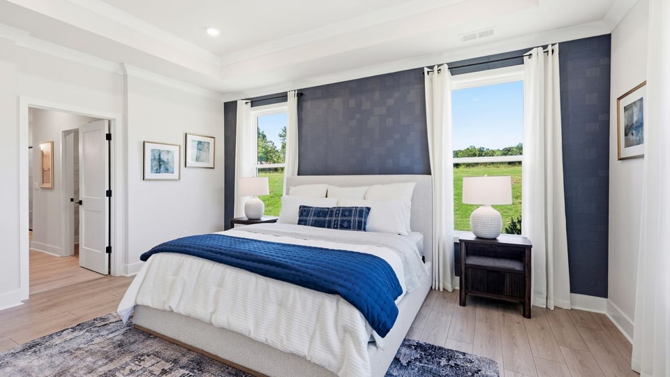 Bedroom with carpet and windows.