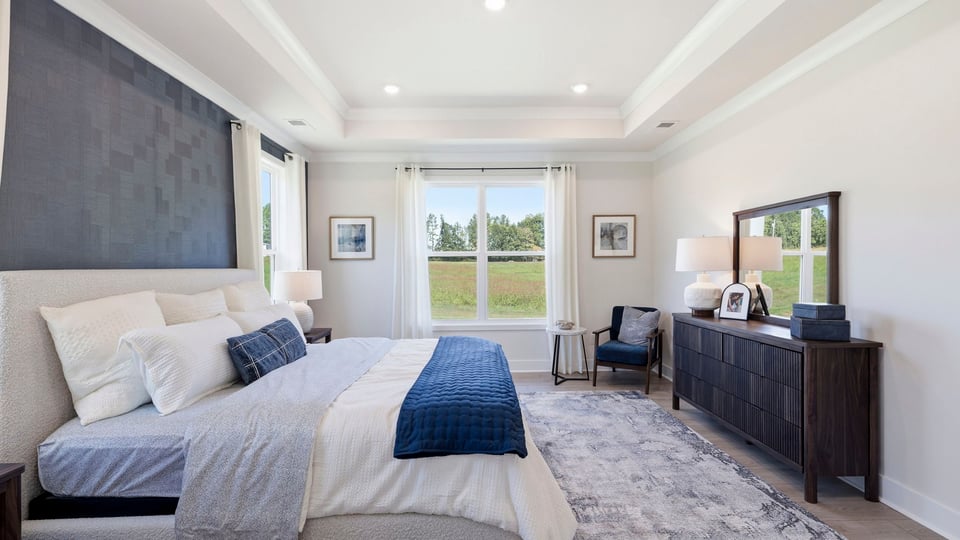 Bedroom with carpet and windows.
