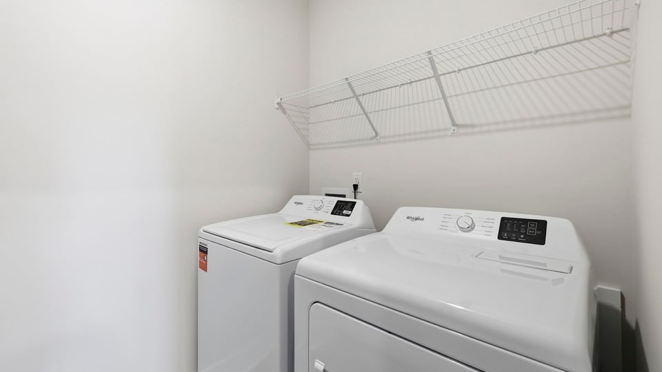 Laundry room with shelf.
