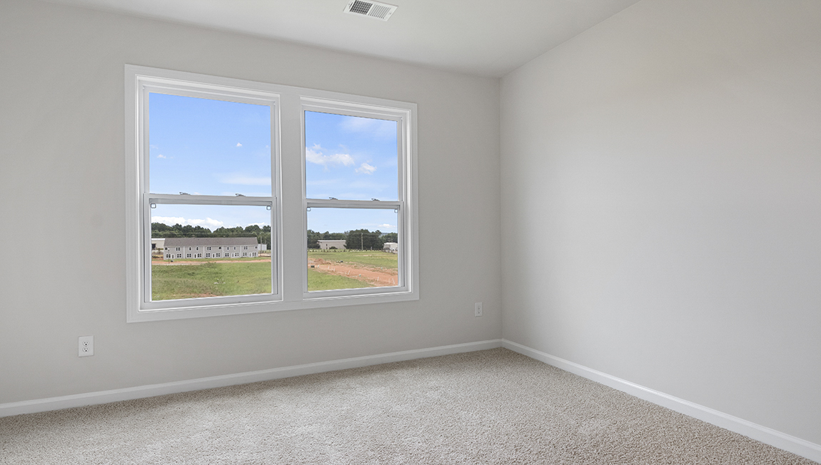 Bedroom with carpet and window.